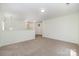 Upstairs loft area with carpet and neutral paint at 15619 Lakepoint Forest Dr, Charlotte, NC 28278