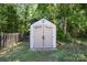 Storage shed in backyard with double doors and adjacent to a fenced yard, ideal for storing tools at 15619 Lakepoint Forest Dr, Charlotte, NC 28278