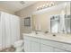 Bathroom featuring a double vanity, large mirror, and combination tub and shower with neutral wall colors at 1720 Chamberside Dr, Rock Hill, SC 29730