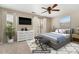 Bedroom featuring a cozy bed, dresser, wall-mounted TV, and a comfortable seating area for relaxation at 1720 Chamberside Dr, Rock Hill, SC 29730