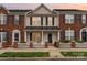 Charming two-story townhome featuring a classic brick facade, black shutters and a welcoming front porch at 1720 Chamberside Dr, Rock Hill, SC 29730