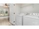 Bright laundry area with washer, dryer, utility shelf, and access to an outdoor space at 1720 Chamberside Dr, Rock Hill, SC 29730