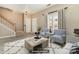 Cozy living room with comfortable seating, bright windows, neutral tones, and staircase access at 1720 Chamberside Dr, Rock Hill, SC 29730
