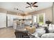 Open-concept kitchen and living area with white cabinets, an island with bar stools, and a comfortable sitting area at 1720 Chamberside Dr, Rock Hill, SC 29730