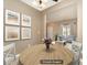 Inviting dining room with an open layout and bright living area enhanced by beach-themed wall art at 1720 Chamberside Dr, Rock Hill, SC 29730
