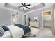 Well-lit main bedroom with a tray ceiling includes a ceiling fan, dresser, and ensuite bathroom access at 1720 Chamberside Dr, Rock Hill, SC 29730