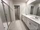 Modern bathroom with a double vanity, sleek fixtures, glass shower, and access to the walk-in closet at 1986 Paddlewheel Dr, Stanley, NC 28164