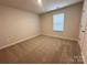 Bedroom featuring neutral walls, carpeted floors, and a window for natural light at 1986 Paddlewheel Dr, Stanley, NC 28164