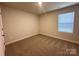 This bedroom features neutral walls, carpeted floors, and a window for natural light at 1986 Paddlewheel Dr, Stanley, NC 28164