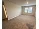 A comfortable bedroom featuring plush carpeting, natural light, and a peaceful ambiance for relaxation and rest at 1986 Paddlewheel Dr, Stanley, NC 28164