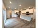 Spacious open-concept kitchen with white cabinets, a central island, and stainless steel appliances at 1986 Paddlewheel Dr, Stanley, NC 28164
