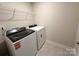 Well-equipped laundry room with modern washer and dryer, plus extra shelving for convenient storage at 1986 Paddlewheel Dr, Stanley, NC 28164