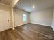 Well-lit living room with hardwood floors, neutral walls, and an open doorway, providing a welcoming atmosphere at 1986 Paddlewheel Dr, Stanley, NC 28164