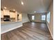 Open-concept living space with hardwood floors, connecting seamlessly to the kitchen, perfect for modern living at 1986 Paddlewheel Dr, Stanley, NC 28164