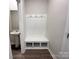 A welcoming mudroom area with built-in storage bench, hooks, and a convenient powder room, ideal for organization at 1986 Paddlewheel Dr, Stanley, NC 28164