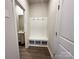 Functional mudroom with bench seating, coat hooks, and storage cubbies, enhancing organization at 1986 Paddlewheel Dr, Stanley, NC 28164