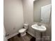 Modern powder room with a pedestal sink, toilet, and a neutral color scheme at 1986 Paddlewheel Dr, Stanley, NC 28164