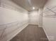 Walk-in closet with extensive shelving, providing ample storage space and organization for your wardrobe at 1986 Paddlewheel Dr, Stanley, NC 28164