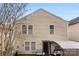 An exterior shot of a two story home's backyard with chairs, tables, and a small area covered by a canvas roof at 2011 Dunsmore Ln # 137, Waxhaw, NC 28173