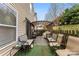 An exterior shot of a backyard with chairs, tables, and an outdoor carpet at 2011 Dunsmore Ln # 137, Waxhaw, NC 28173