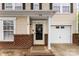 Charming home featuring a brick facade, attached garage, and a welcoming front entrance at 2011 Dunsmore Ln # 137, Waxhaw, NC 28173