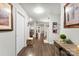 Hallway with hardwood floors leads to a kitchen and dining area at 2011 Dunsmore Ln # 137, Waxhaw, NC 28173