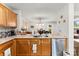 The kitchen has stainless steel appliances and wooden cabinetry, open to the dining area at 2011 Dunsmore Ln # 137, Waxhaw, NC 28173