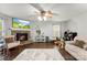 Inviting living room featuring a stone fireplace, hardwood floors, and a ceiling fan at 2011 Dunsmore Ln # 137, Waxhaw, NC 28173