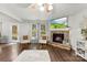 Living room featuring a fireplace with a stone hearth, a ceiling fan, and hardwood floors at 2011 Dunsmore Ln # 137, Waxhaw, NC 28173