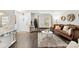 Open-concept living room with hardwood floors, a cozy seating area, and ample natural light at 2011 Dunsmore Ln # 137, Waxhaw, NC 28173