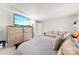 Bright main bedroom featuring a large TV, hardwood dresser, and comfortable couch with decorative pillows at 2011 Dunsmore Ln # 137, Waxhaw, NC 28173