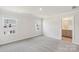 Spacious bedroom featuring neutral walls and soft carpet, with multiple windows for natural light at 2020 Old Rivers Rd, Concord, NC 28027