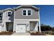 Charming two-story townhome features a one-car garage and welcoming front entrance at 2020 Old Rivers Rd, Concord, NC 28027