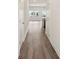 Hallway leading to an open space with hardwood floors and neutral paint throughout at 2020 Old Rivers Rd, Concord, NC 28027
