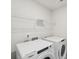 Convenient laundry room equipped with a washing machine, dryer, and shelving for storage at 2020 Old Rivers Rd, Concord, NC 28027