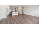 Open-concept space with modern kitchen and living room, showcasing hardwood floors and neutral paint at 2020 Old Rivers Rd, Concord, NC 28027