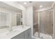 Bathroom featuring a double vanity, quartz countertop, and glass-enclosed shower at 2070 Old Rivers Rd, Concord, NC 28027