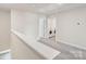 Upstairs hallway with laundry room at 2070 Old Rivers Rd, Concord, NC 28027