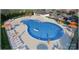 Aerial view of a community pool with ample seating, umbrellas, and a clubhouse creating a resort-style living at 2070 Old Rivers Rd, Concord, NC 28027
