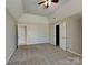 Spacious bedroom with plush carpet, a walk-in closet, and neutral paint at 2122 Shumard Cir, Indian Trail, NC 28079