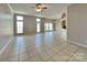 Open-concept living room boasts tile floors, bright windows, and elegant lighting at 2122 Shumard Cir, Indian Trail, NC 28079