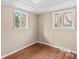 Bedroom featuring two windows, natural light, and wood flooring at 216 E Georgia Ave, Bessemer City, NC 28016