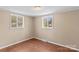 Bright bedroom with two windows and hardwood floors at 216 E Georgia Ave, Bessemer City, NC 28016