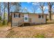 Charming tan home with black trim and front porch on a lovely treed lot at 216 E Georgia Ave, Bessemer City, NC 28016