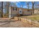 Tan home with black trim and a small front porch situated on a lovely lot at 216 E Georgia Ave, Bessemer City, NC 28016