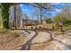 A single-story home with wood siding, a small front porch, and landscaped elements at 216 E Georgia Ave, Bessemer City, NC 28016