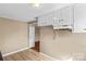 Kitchen featuring plenty of cabinet space and an adjacent doorway into another room at 216 E Georgia Ave, Bessemer City, NC 28016
