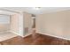 Bright living room with hardwood floors, neutral walls, and ample natural light at 216 E Georgia Ave, Bessemer City, NC 28016