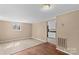 Open-concept living area with hardwood floors, neutral walls, and lots of natural light at 216 E Georgia Ave, Bessemer City, NC 28016