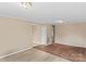 Spacious living room with hardwood floors and neutral walls leading to other areas at 216 E Georgia Ave, Bessemer City, NC 28016
